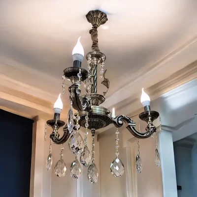 نجفة نحاسية مزينة بكريستالات عصفور البراقة، تصميم أنيق وفاخر مكون من 3 أذرع بتفاصيل دقيقة. مثالية لإضاءة غرف المعيشة أو غرفة الطعام.