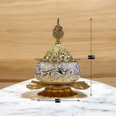 مبخرة ذهبية فاخرة، بزخارف عربية إسلامية ، موديل 029412 أبعاد المبخرة كما تظهر على الصورة: قطر القاعدة 6 سم والارتفاع الكلى 15 سم.
