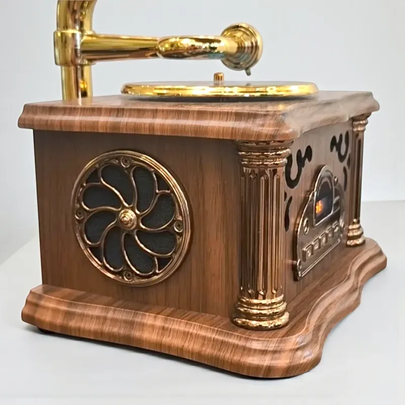 إخوان سرور الإضاءة الحديثة والديكور منظر جانبي مقرب لجراموفون مصغر يظهر شبكة السماعة المزخرفة باللون النحاسي والأعمدة الخشبية للديكور العتيق.