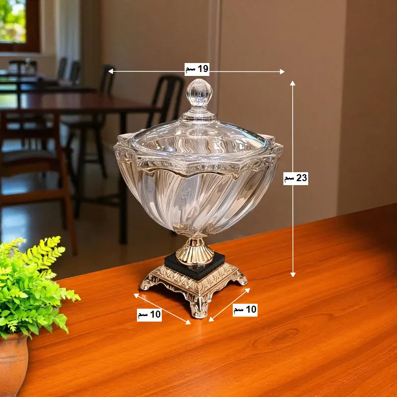 إخوان سرور الإضاءة الحديثة والديكور صورة توضح مقاسات البونبونيرة الكريستال: الارتفاع 23 سم، العرض 19 سم، والقاعدة 10x10 سم.